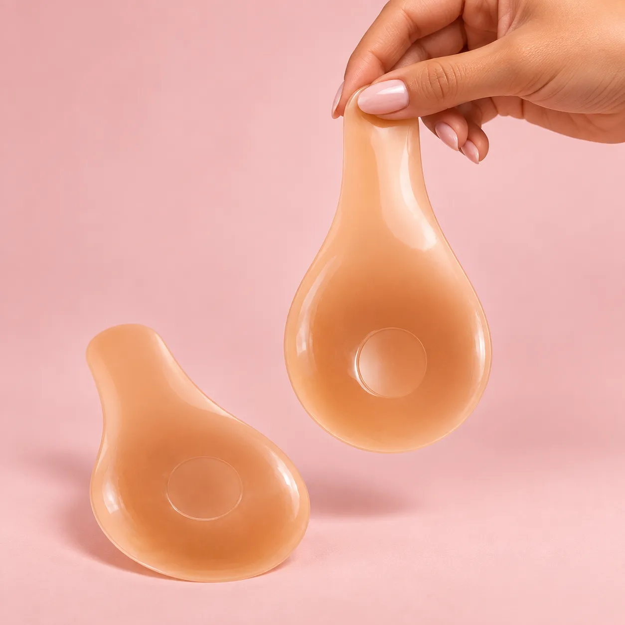 Hand holding a Zayra Belle Lift silicone cover by its lifting tab